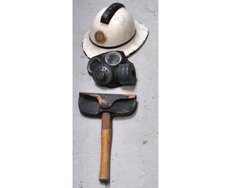 A fireman station officer's cap, a Widnes Fire Station helmet, a WWII gas mask, a fireman's jacket and an axe (5).