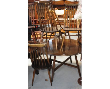 A mid 20th century Ercol drop leaf dining table with four matching stick back chairs (5).