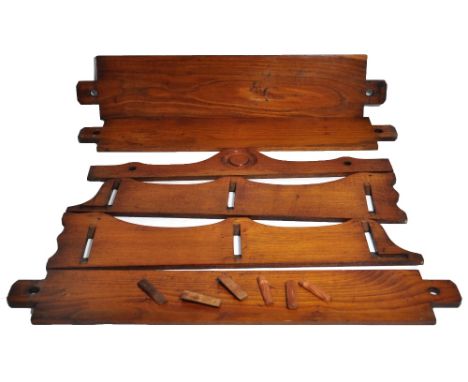 An early 20th century oak wall mounted shelf with three tiers with shaped sides and carved decoration.