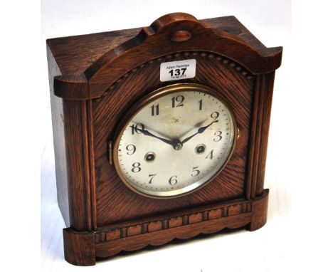 A 20th century oak cased domed top mantel clock, with silvered dial set with Arabic numerals, height 28cm.