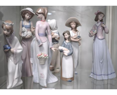 Two Nao figures of girls one holding a flower basket and one holding a dog and five Lladro figures of ladies one holding a pi