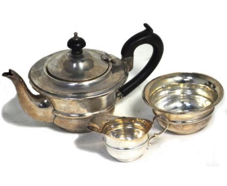 A George V hallmarked silver miniature teapot and sugar basin, Chester 1913, also a hallmarked silver milk jug Birmingham 191