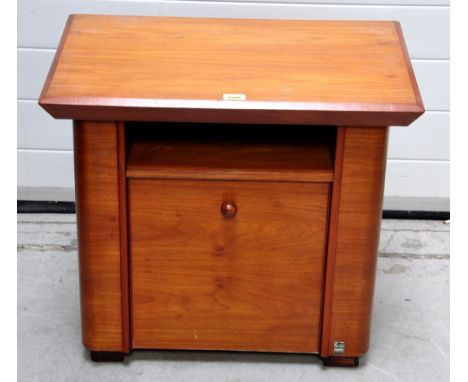 An Art Deco satin walnut magazine/side table, the moulded rectangular top above shelf and fall front section bearing label in