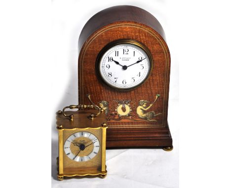 An Edwardian mahogany and inlaid timepiece with cherubic decoration and enamelled dial set with Arabic numerals inscribed R. 
