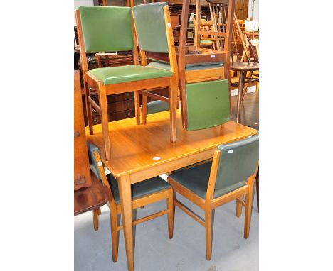 A Gordon Russell of Broadway eight piece dining room suite comprising table, six chairs and sideboard. CONDITION REPORT Light