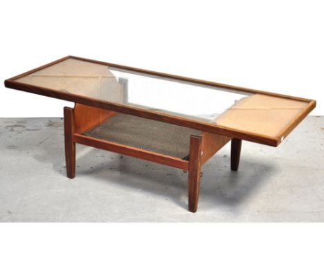 A retro 1970s light oak glass topped rectangular coffee table, the glass raised on curved wooden supports, with lower tier on