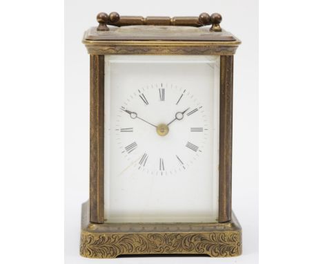 A 20th century engraved brass cased hourly striking carriage clock, the white enamelled dial with black Roman numerals, the m