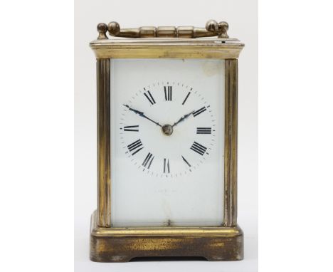 A 20th century brass corniche cased hourly striking carriage clock, the white dial with black Roman numerals, striking on a g