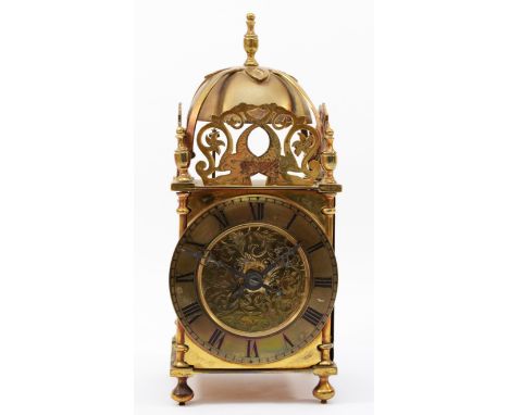 A brass lantern clock, early 20th century, striking on a bell, with pierced fretwork decoration, the chapter ring with black 