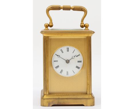 A 20th century brass corniche cased striking carriage clock, striking on the half hour, with applied brass engine turned pane