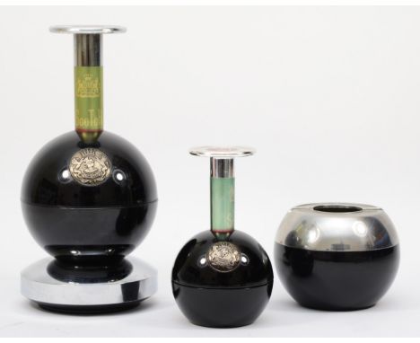 A mid 20th century black plastic and chrome plated three piece Lady Mate smokers set comprising of a musical cigarette dispen