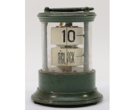 A 20th century flip ticket clock, in a green painted tin and glass cylindrical and glass case, with carrying handle raised on
