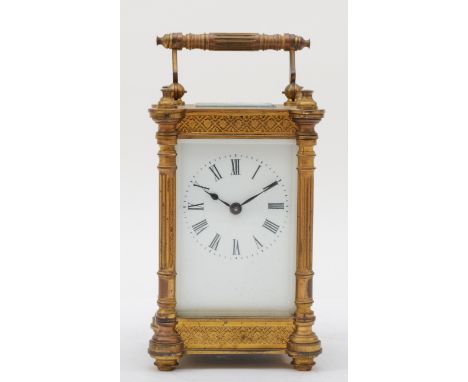 A 20th century French brass corniche cased carriage clock, the white dial with black Roman numerals, with blind fretwork deco