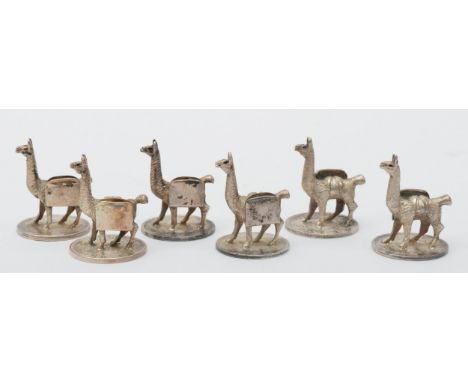 An unusual set of six Bolivian cast silver lama menu/place name holders, raised on 1882 - 1900 silver 20 cent coins, height 3