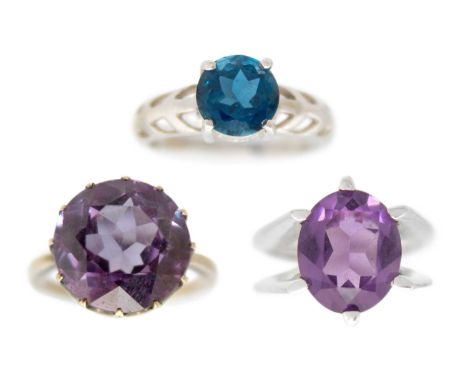 Three gem-set dress rings. One set with a large colour change corundum, set in white gold, size J, a 9ct white gold blue topa