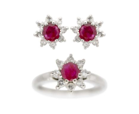 A 14ct white gold ruby and diamond set cluster ring with matching stud earrings. The ring with round cut ruby measuring 4.8 x