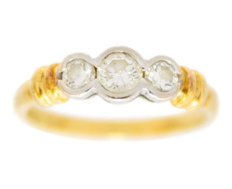 A modern 18ct hallmarked yellow and white gold diamond set three-stone ring. The collet set diamonds of 0.50ct total weight, 