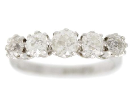 A platinum five-stone old cut diamond set ring. The graduated stones estimated at 1.15ct total weight, stamped PLATINUM, size