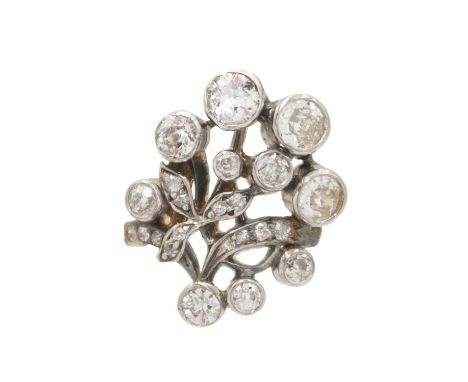 An attractive late 19th-century continental diamond set foliate spray design ring. The old mine cut diamonds in a white metal
