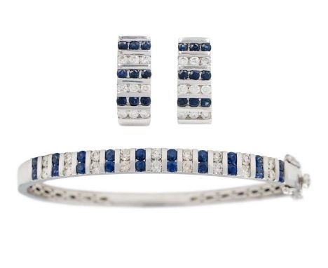 A  good modern 14ct white gold diamond and sapphire set hinged bangle with matching earrings. The bangle set with 18 channel 