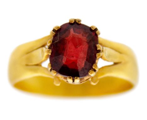 A Victorian 22ct band ring, later applied with an oval cut garnet. The band hallmarked Birmingham 1893, size R, 4.5g.
