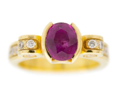 A modern heavy 18ct diamond and pink stone, possibly almandine garnet, set dress ring. The oval cut stone of 1.40ct estimated
