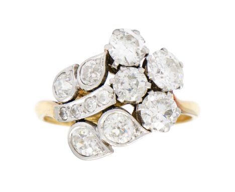 An exquisite Art Deco 18ct gold and platinum diamond set floral design ring. Set with 12 round brilliant cut diamonds, design