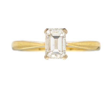 A modern 18ct emerald cut diamond solitaire ring. The diamond of estimated 0.80ct weight, of good clarity and white colour, m