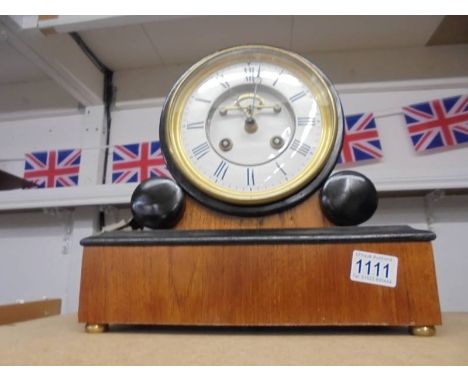A Bracket clock with 5.5" dial, open excapement, mahogany case, bell striking, with key and pendulum, in working order.