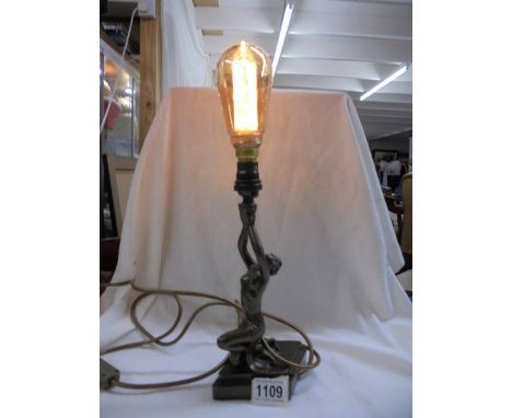 An art deco style figural table lamp.