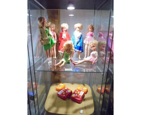 A quantity of Sindy Dolls and Barbie dolls with accessories in a vintage vanity case.