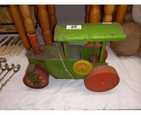 A vintage tinplate clockwork steam roller