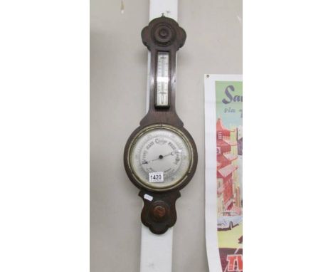 An oak barometer/thermometer.