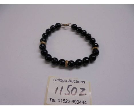 A vintage bracelet with gold clasp.