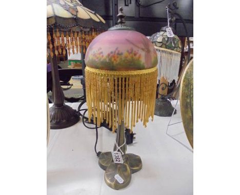 A table lamp with beaded dragonfly shade.