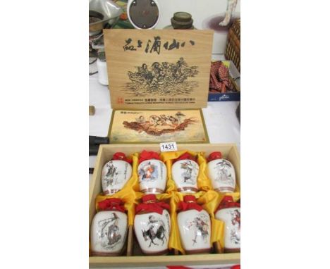 A cased set of 8 porcelain jars with liquid contents from Taiwan Tobbaco &amp; Wine Monopoly Bureau, Republic of China.