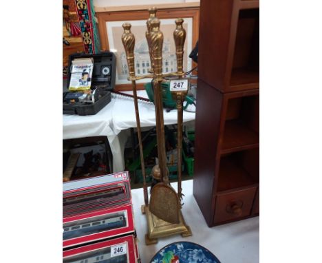 A brass companion set (fire irons/fire tools)
