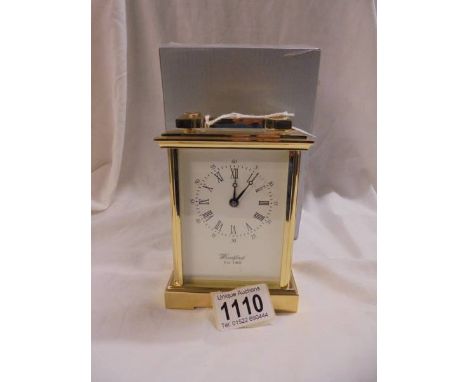 A good quality brass carriage clock by Woodford, Est. 1860 with key and boxed, in working order.
