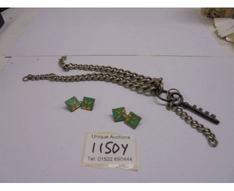 A white metal watch chain and a pair of enamel cuff links.