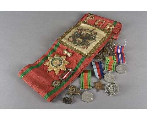 A silver Masonic jewel for the Ancient Order of Foresters, together with a sash having PCR metal lettering above a coat of ar