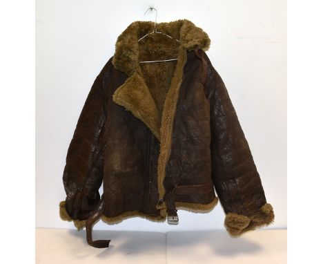 A WWII brown leather flying jacket, unnamed, together with a military pocket compass in leather case, AF, plus a book on the 