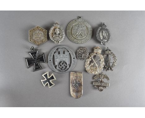 A group of German badges and medallions, including German Army Air Gunners, Imperial Naval badge, Lorient Shield First type, 