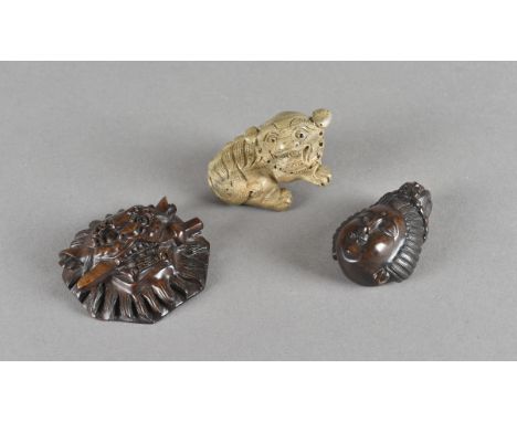 A Japanese boxwood carved netsuke, modelled as Geisha head with ornate head dress, another of Buddhistic lion dog, boxwood ca