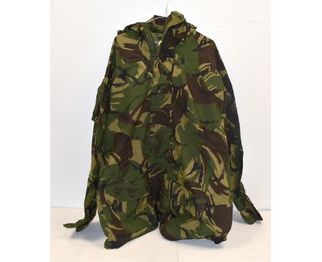 An assortment of Army clothing, including a Smock Combat, other hooded jackets, in camo and olive, a heavy olive drab, waterp