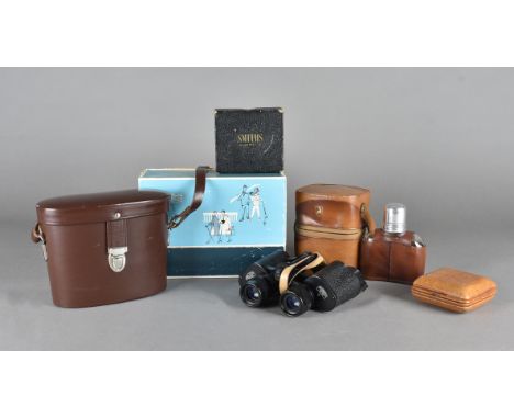 A cased pair of Carl Zeiss binoculars, in leather case, a Smiths leather travel clock and a pair of travelling hip flasks 