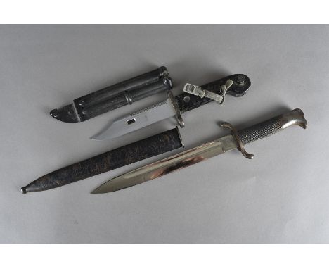 A German AKM bayonet, marked 1946/2 to scabbard, together with a WWII period German dress bayonet by Solingen 