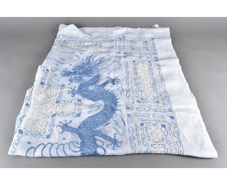 An early 20th Century cotton and Peking knot embroidered table cloth, depicting the blue dragons and the flaming pearl, surro