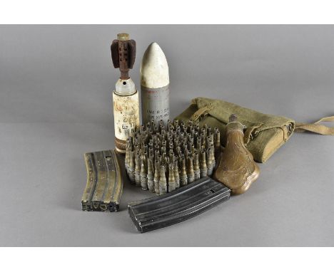 An assortment of shells and accessories, including a 2.25'' Type 5079 Mk2 shell, a mortar, various sized shells, gun cleaning