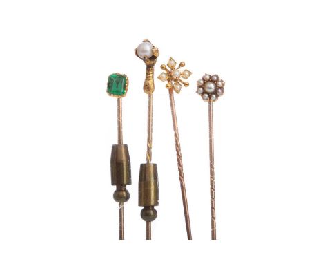 FOUR STICK PINS,including an eagle claw example and two seed pearl clusters, each unmarked (4)