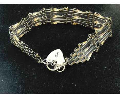 9ct gold gate bracelet with heart shaped locket and safety chain, weight 10.7grams
